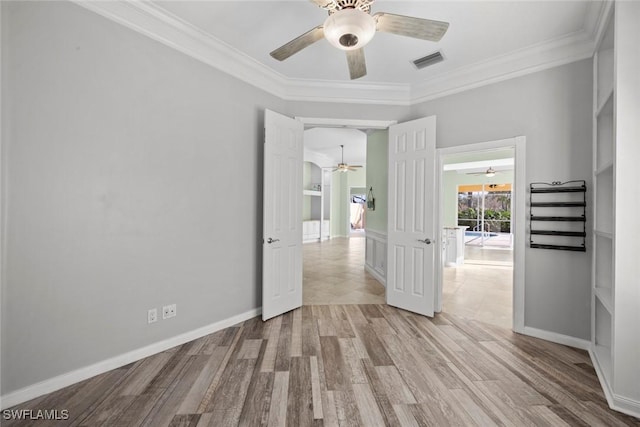 spare room featuring ornamental molding and light wood-type flooring