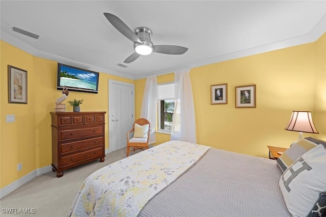 bedroom with ceiling fan, visible vents, crown molding, and light colored carpet