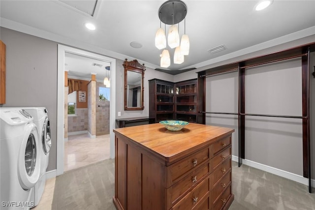 spacious closet featuring light carpet and washer and dryer