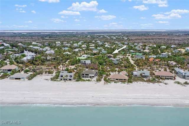 drone / aerial view with a water view and a beach view