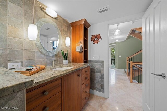 bathroom featuring tile walls and vanity