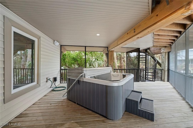 sunroom / solarium featuring a jacuzzi and a healthy amount of sunlight