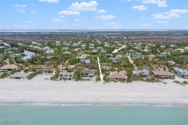 drone / aerial view with a water view, a residential view, and a beach view