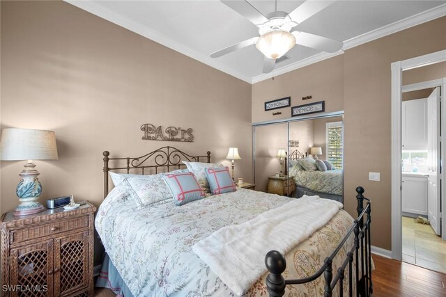 bedroom featuring hardwood / wood-style floors, ceiling fan, and crown molding