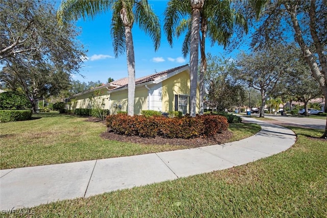 view of home's exterior with a yard