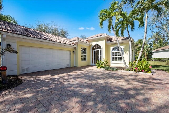 mediterranean / spanish house with a garage