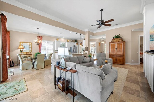 living room featuring crown molding and ceiling fan with notable chandelier