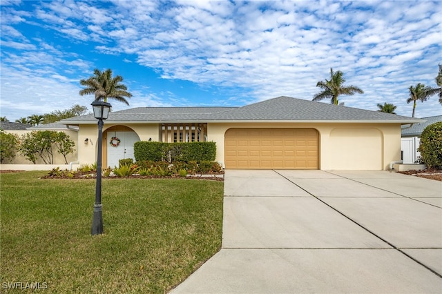 ranch-style home featuring a garage and a front yard