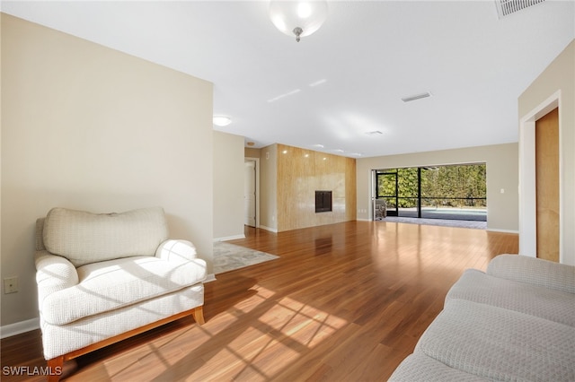 living room featuring a premium fireplace and hardwood / wood-style floors