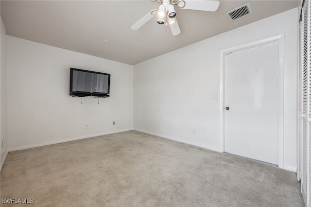 carpeted empty room featuring ceiling fan