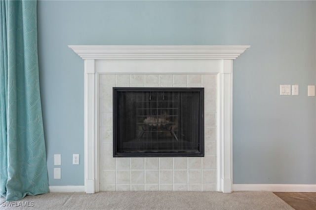 room details featuring carpet flooring and a fireplace