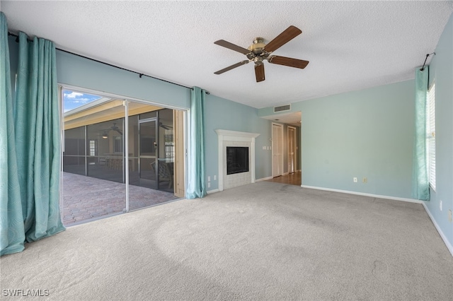 unfurnished living room with a textured ceiling, ceiling fan, and carpet flooring