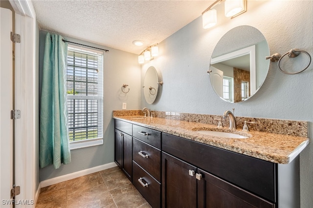 bathroom featuring vanity and a textured ceiling