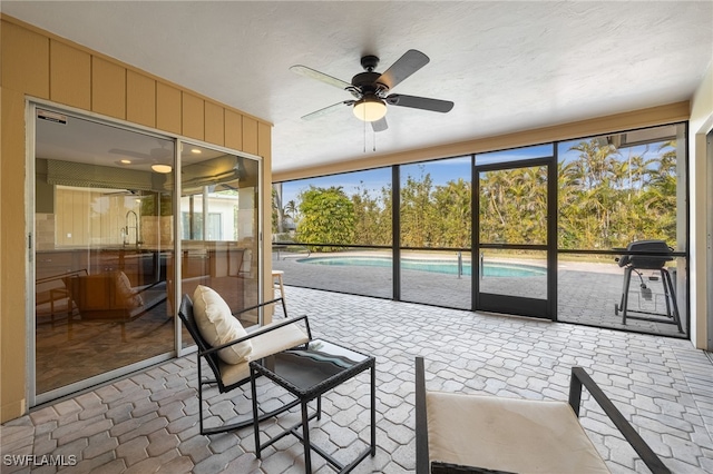 sunroom / solarium with ceiling fan