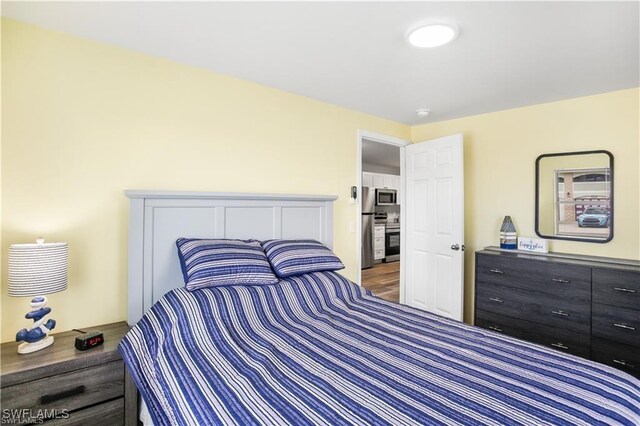 bedroom with hardwood / wood-style floors