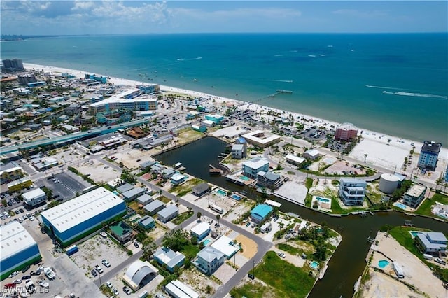 bird's eye view featuring a water view and a beach view