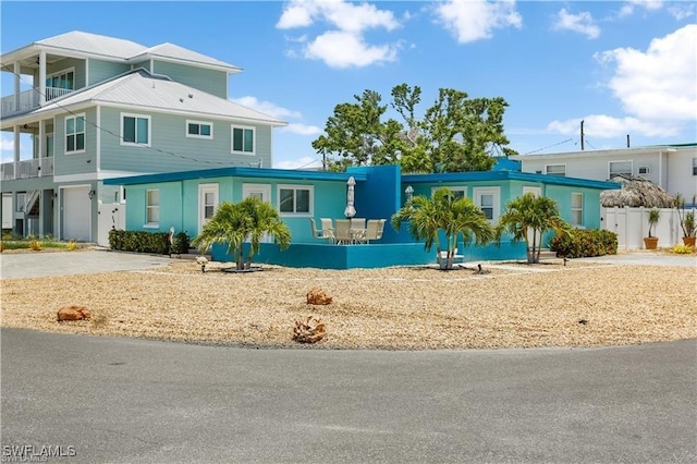 view of front facade with a garage and a balcony