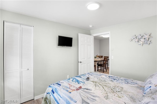 bedroom with wood-type flooring and a closet