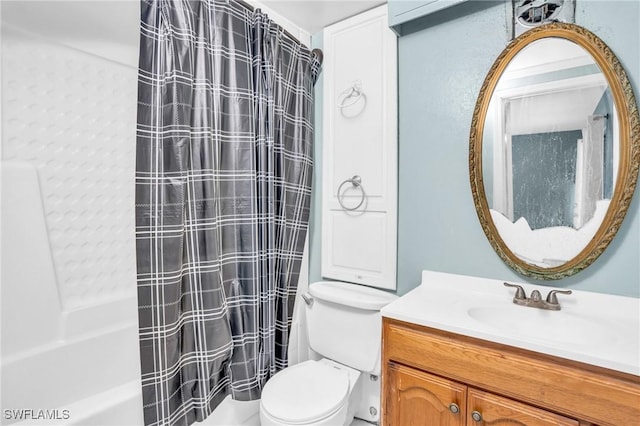 full bathroom featuring shower / bath combination with curtain, vanity, and toilet