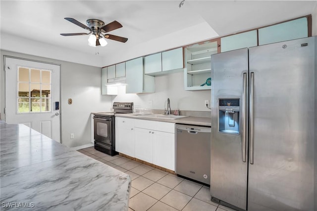 kitchen featuring stainless steel appliances, ceiling fan, sink, white cabinets, and light tile patterned flooring