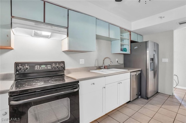 kitchen with white cabinets, appliances with stainless steel finishes, light tile patterned floors, and sink