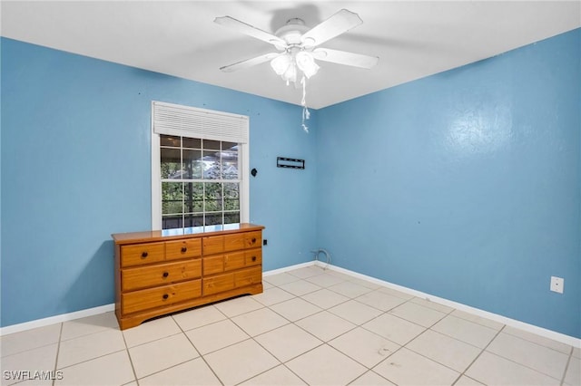 unfurnished room with ceiling fan and light tile patterned floors