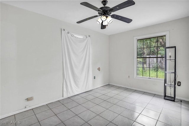 empty room featuring ceiling fan and light tile patterned floors