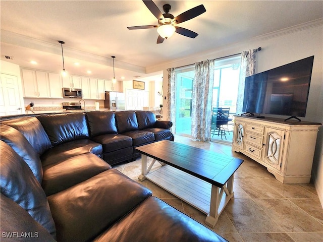 living room with crown molding, light tile patterned flooring, and ceiling fan