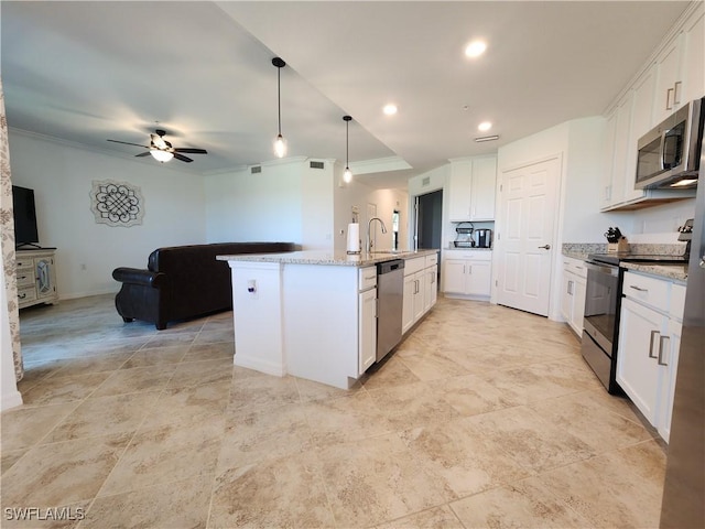 kitchen with light stone countertops, appliances with stainless steel finishes, white cabinetry, an island with sink, and ceiling fan