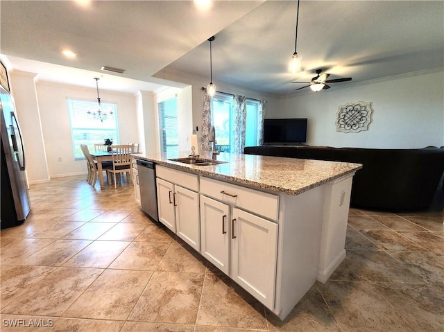 kitchen with appliances with stainless steel finishes, a kitchen island with sink, sink, decorative light fixtures, and white cabinets