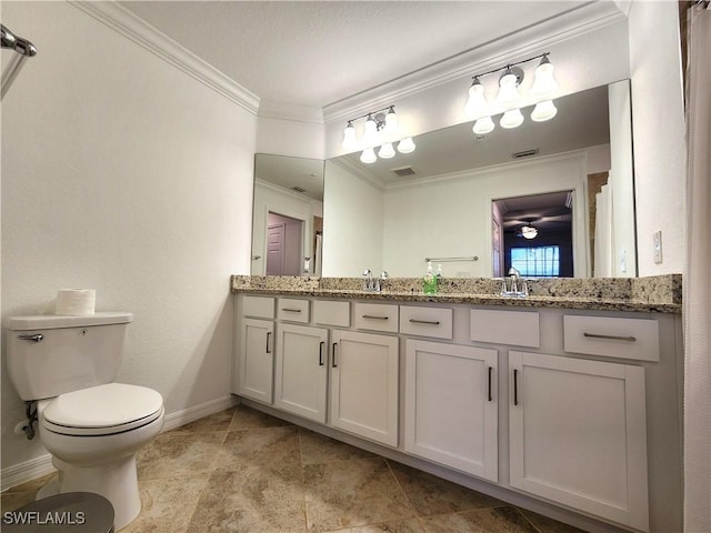 bathroom featuring toilet, vanity, and ornamental molding