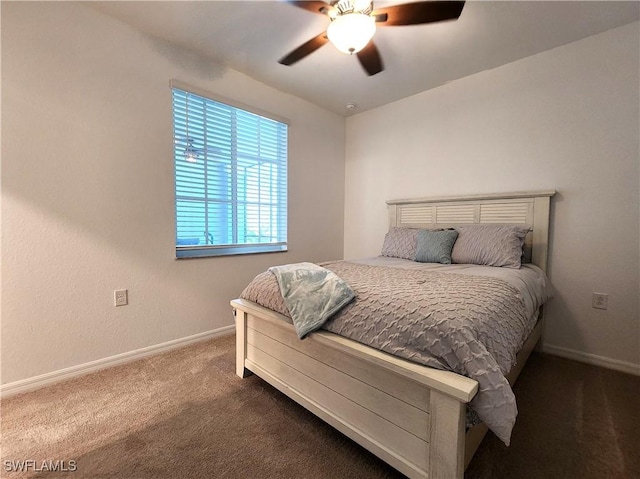 bedroom featuring ceiling fan and dark colored carpet