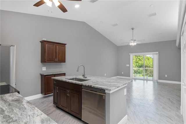 kitchen with sink, a center island with sink, lofted ceiling, appliances with stainless steel finishes, and dark brown cabinetry