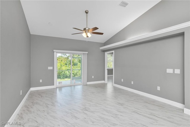 empty room with ceiling fan and vaulted ceiling