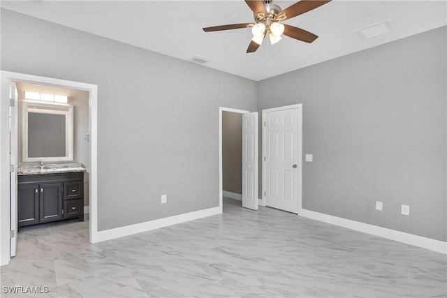 unfurnished bedroom featuring ensuite bathroom and ceiling fan