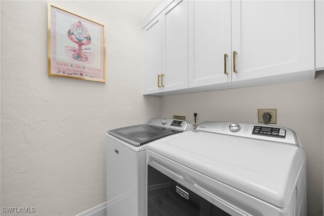 laundry room featuring cabinets and washer and dryer