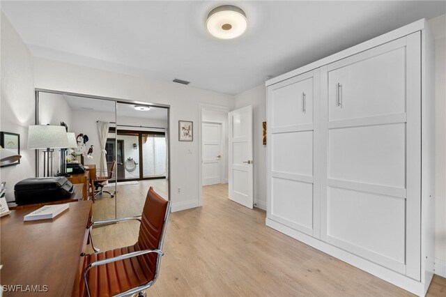 office with light wood-type flooring