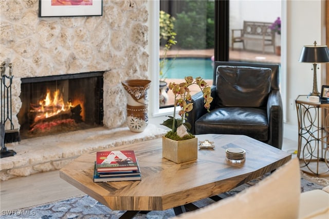 585 Bay Villas Ln Unit 88, Naples, FL 34108 - living room featuring wood finished floors and a stone fireplace