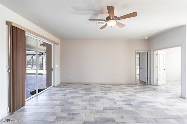 empty room featuring a ceiling fan, visible vents, and baseboards