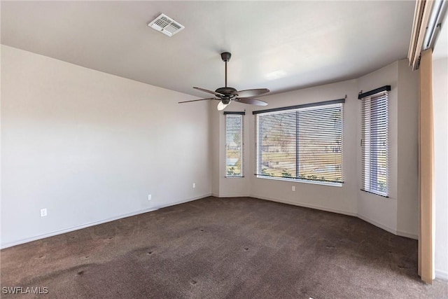 spare room featuring baseboards, visible vents, carpet floors, and ceiling fan