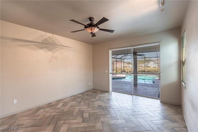 empty room featuring ceiling fan and light parquet floors