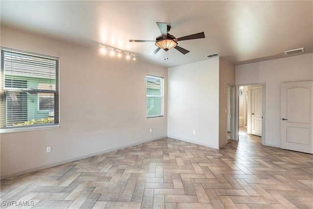 empty room featuring light parquet floors and ceiling fan