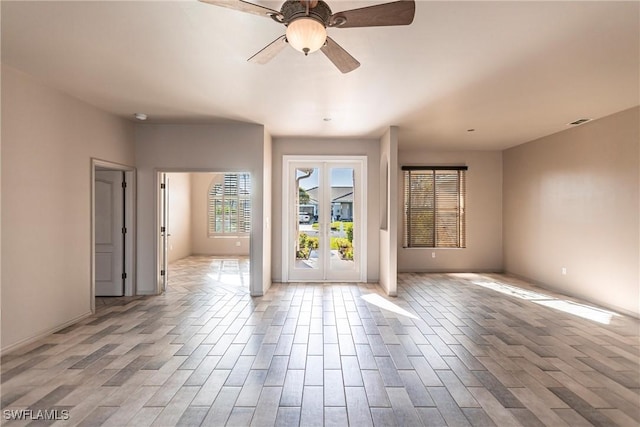 spare room featuring light hardwood / wood-style floors, french doors, and ceiling fan