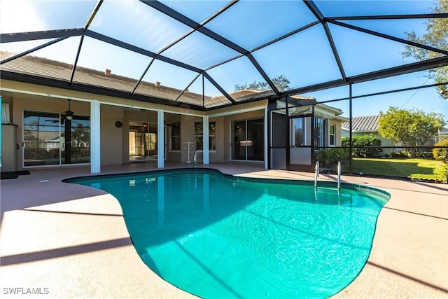 outdoor pool featuring glass enclosure, a patio, and ceiling fan