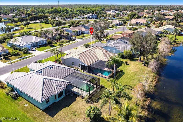 drone / aerial view with a residential view and a water view