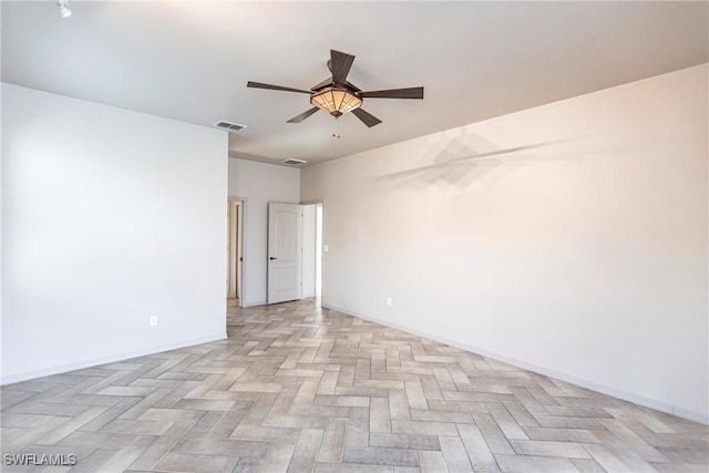 spare room featuring light parquet floors and ceiling fan