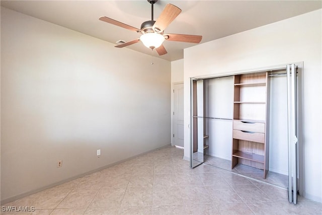 unfurnished bedroom featuring visible vents, baseboards, light tile patterned floors, a closet, and a ceiling fan