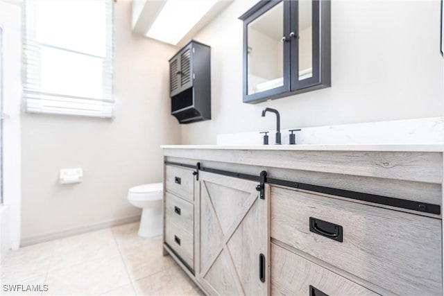 bathroom featuring vanity, tile patterned floors, toilet, and baseboards