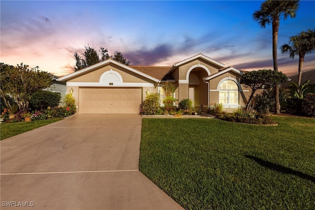 ranch-style house with a front lawn, an attached garage, driveway, and stucco siding