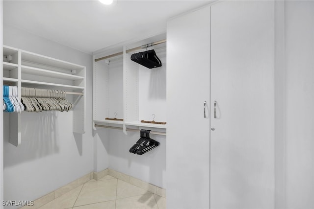 walk in closet with light tile patterned flooring